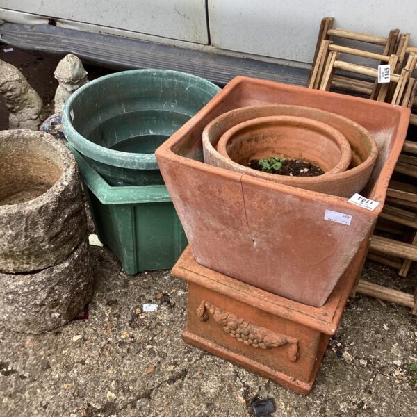 Lot of weathered terracotta garden pots for outdoor planting.