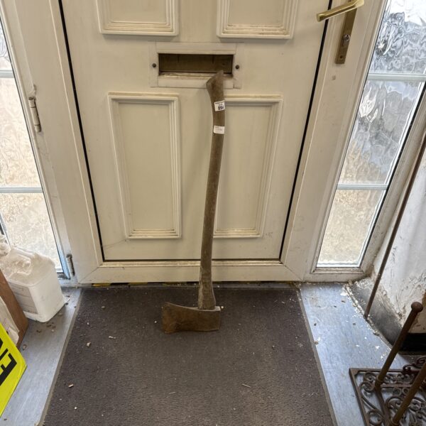 Vintage wood axe with a long handle, ideal for forestry work.