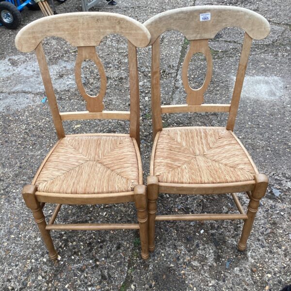 Vintage woven seat dining chairs with wooden frames.