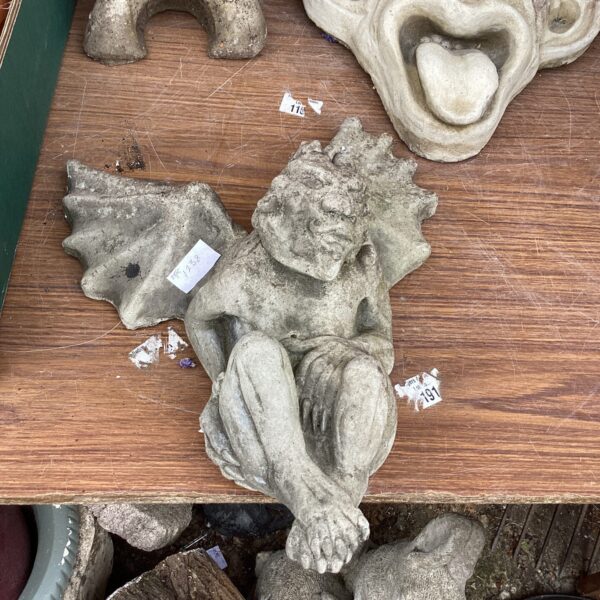 Vintage gargoyle wall ornament with a grotesque face.