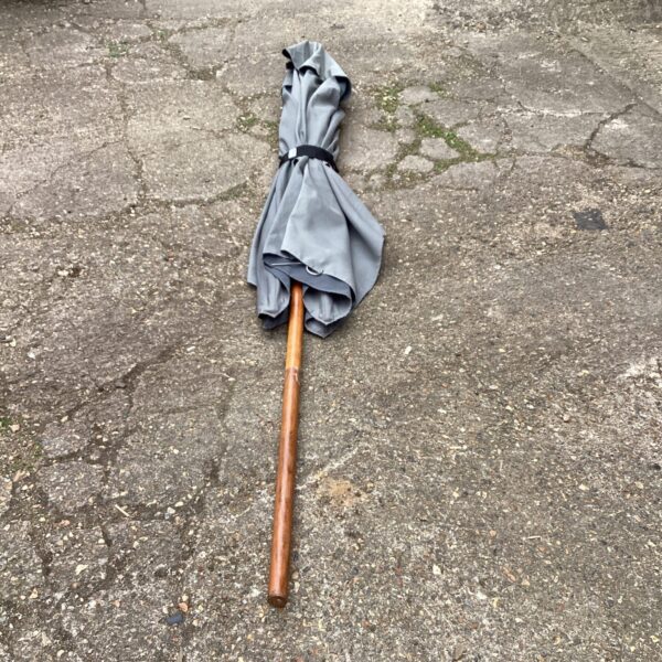 Grey rectangular garden parasol with wooden pole.