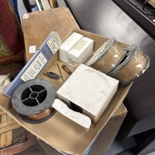 Tray of mixed mig welding wire spools for metalworking projects.