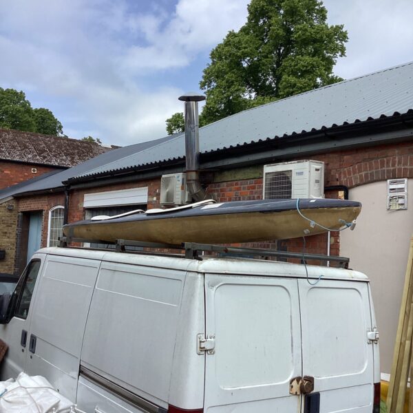 Two person canoe secured to a vehicle roof rack.