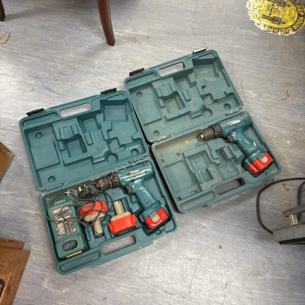 Two Makita cordless drills in carrying cases, battery powered tools.