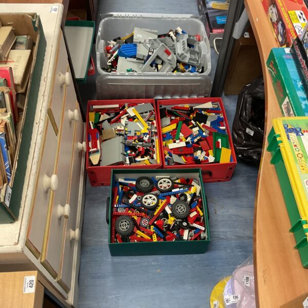Large boxes filled with mixed Lego bricks and building blocks.