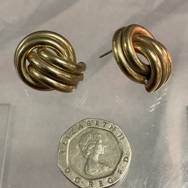 Close-up of 9ct gold twisted hoop earrings with a classic design.