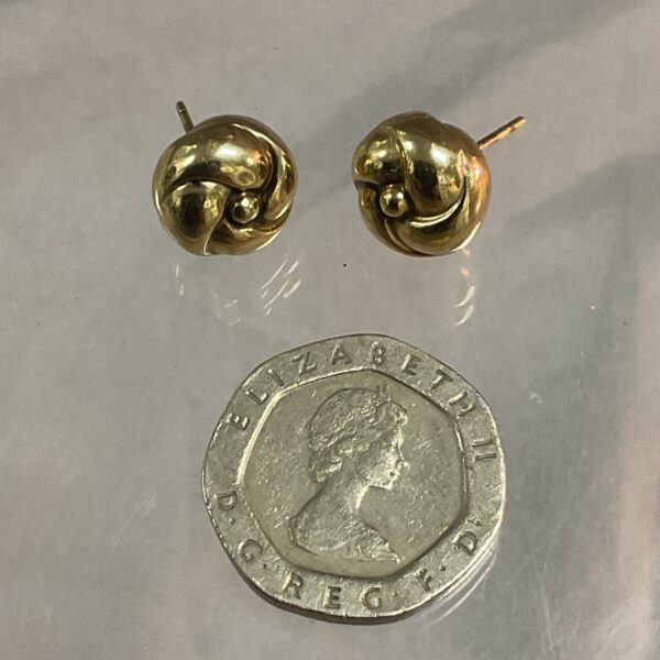 Close-up of 9ct gold ball earrings with butterfly backs.