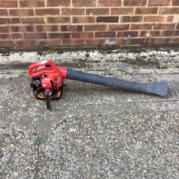 Vintage Little Wonder leaf blower for garden cleanup.