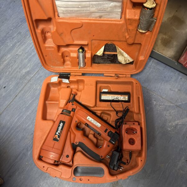 Paslode cordless nail gun in open carrying case.