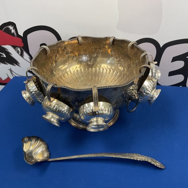 Antique silver on copper punch bowl set with cups and ladle.