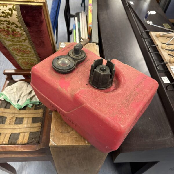 Red vintage Tempo fuel can for outboard motors.