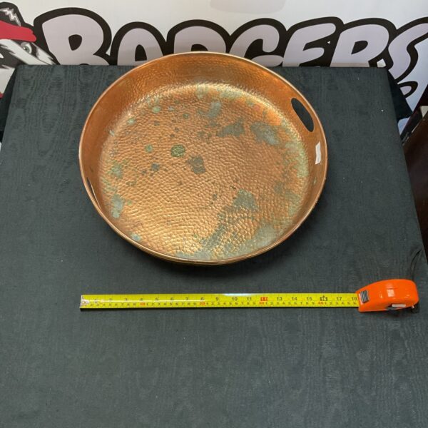 Large vintage copper dish with warm patina.