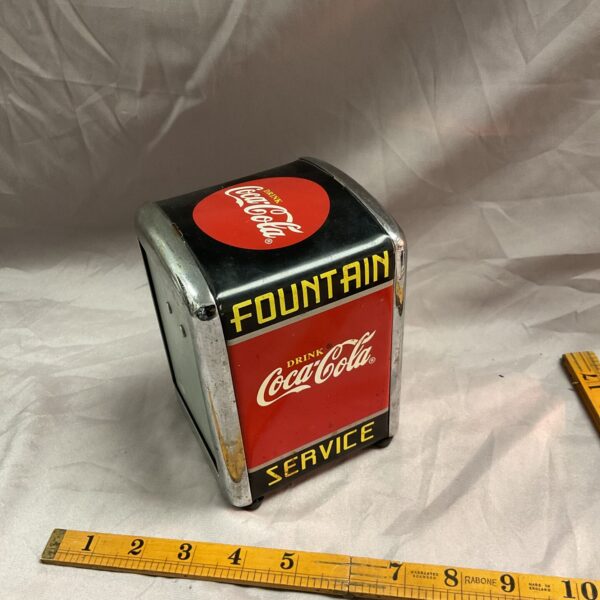 Vintage Coca Cola fountain napkin dispenser for collectors.