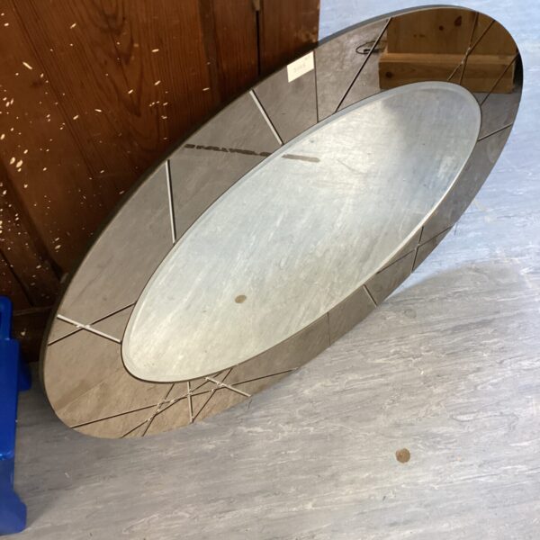 Large vintage oval mirror with silvering imperfections.