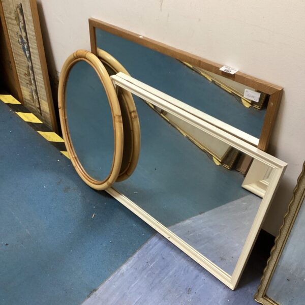 Collection of three vintage wall mirrors for home decor.