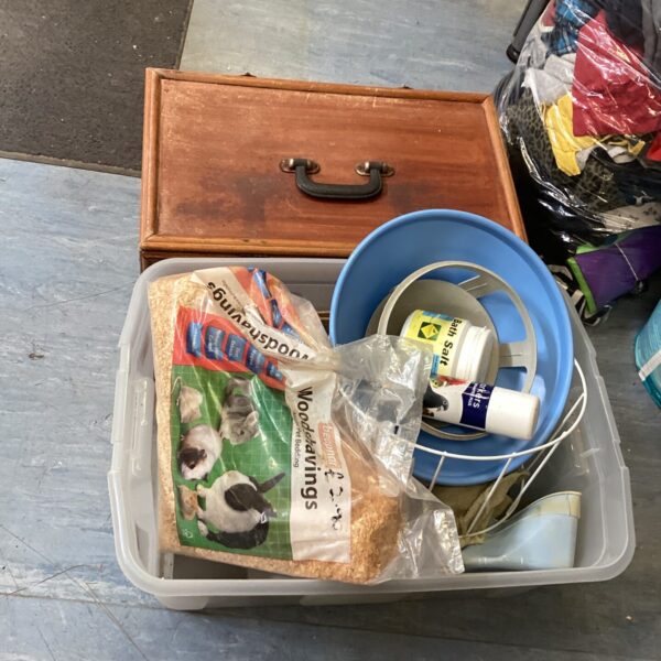 Mixed lot of pet supplies including carrier and bird feed.