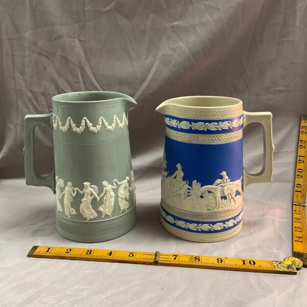 Antique Copeland Jasperware jugs with blue background and white relief figures.