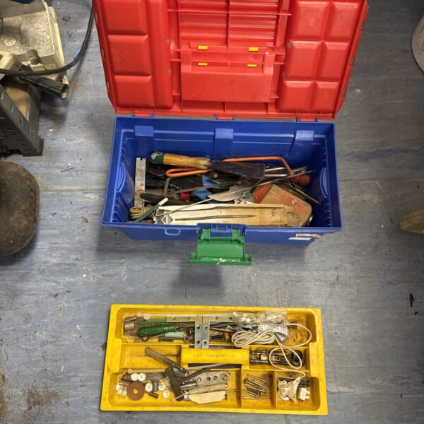 Blue plastic toolbox filled with a variety of vintage hand tools.