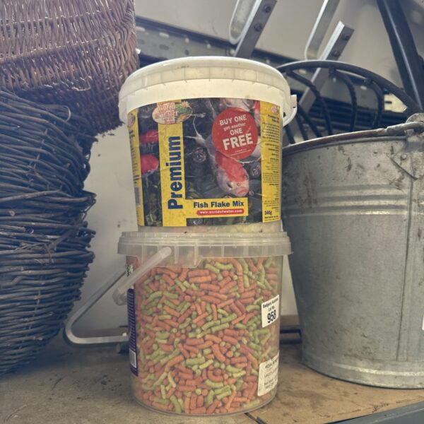 Brightly coloured tub of premium pond fish food pellets.