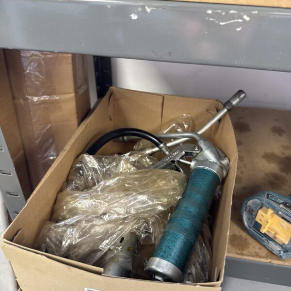 Vintage grease gun with a green finish, a classic lubrication tool.
