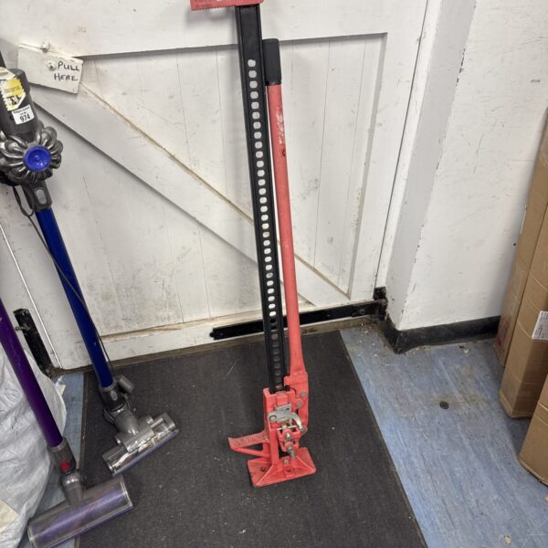 Large metal jack clamp for workshop and automotive repairs.