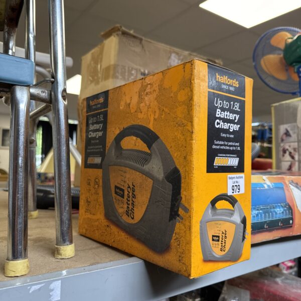 Halfords 12v battery charger in original packaging.