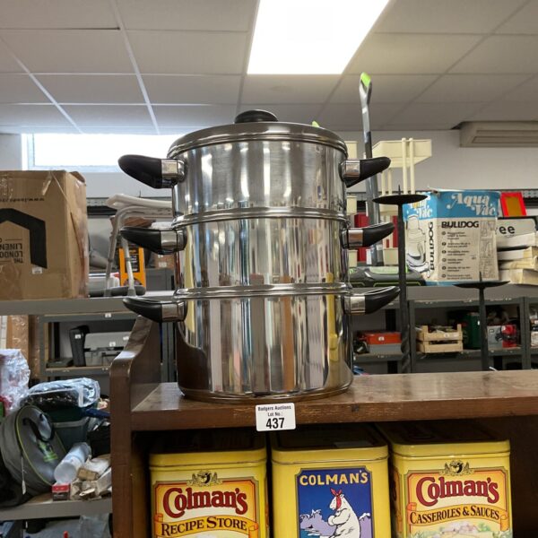 Three-piece stainless steel stockpot set stacked for storage.