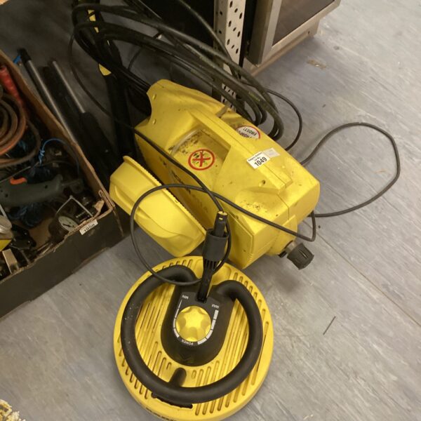 Yellow Karcher 411A pressure washer with hose connections.