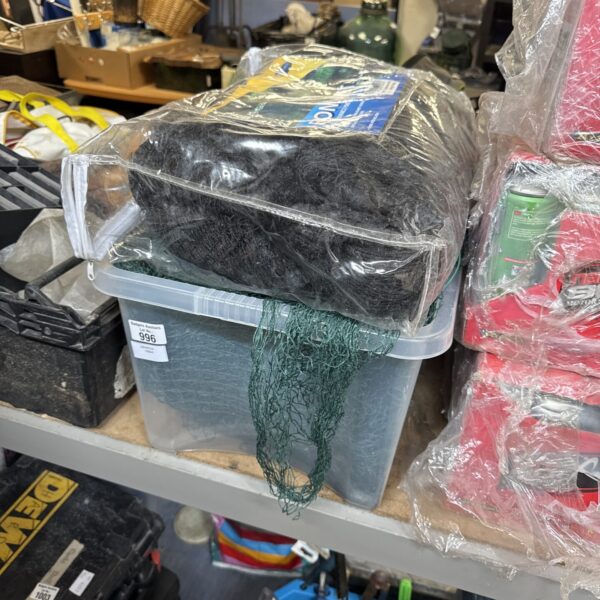 Plastic storage box containing pond netting for garden protection.