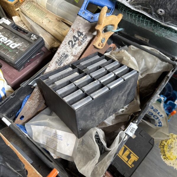 Shed clearance lot with metal blades and tool parts.