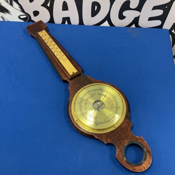 Vintage Weathermaster barometer with wooden frame for wall mounting.