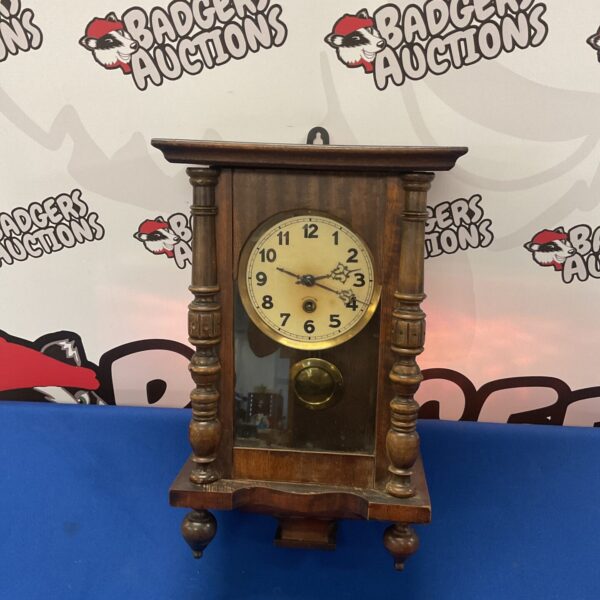 Antique 1906 German wall clock with wooden case.