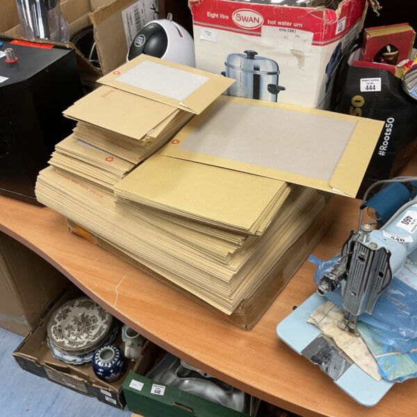 Stack of board-backed envelopes, ideal for mailing and stationery.