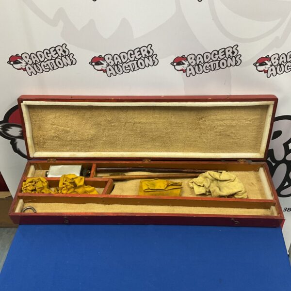Vintage rifle cleaning kit in wooden box, antique gun tools.