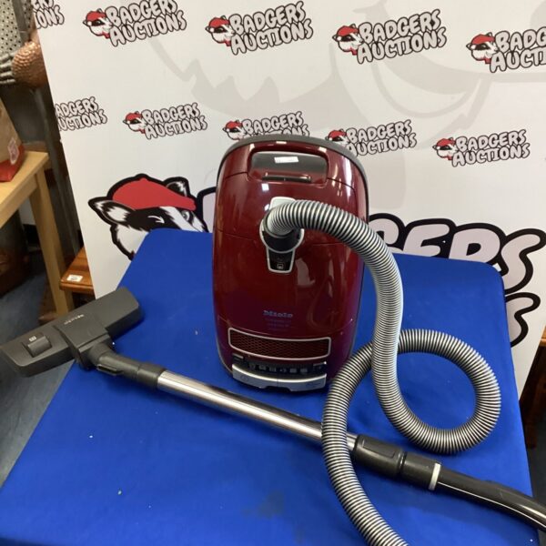 Miele canister vacuum cleaner in a domestic setting.