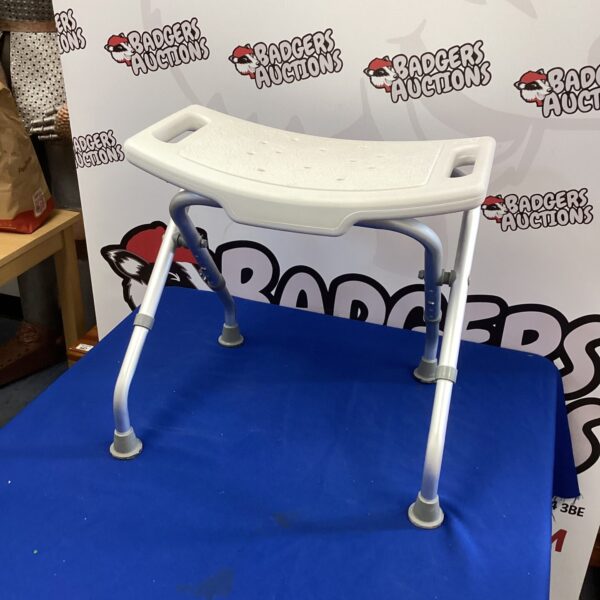 Adjustable folding shower seat for bathroom safety and mobility.