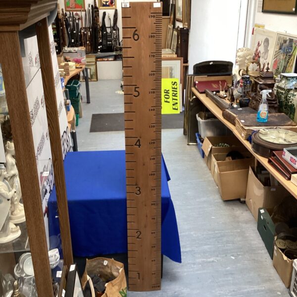 Vintage wooden child's height chart in a room setting.