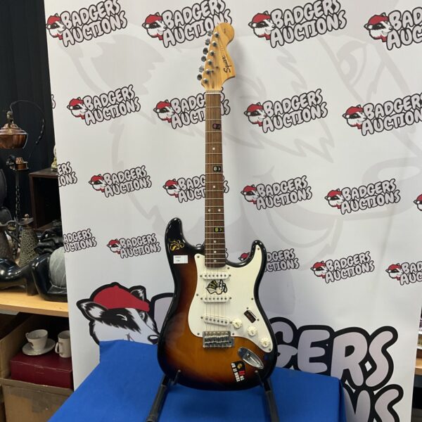 Sunburst Fender Squire Stratocaster electric guitar, vintage style.