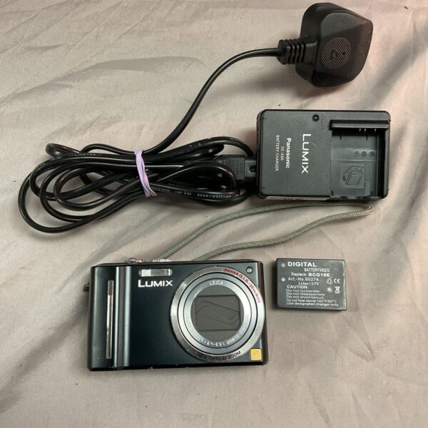 Panasonic Lumix DMC-TZ8 digital camera with battery and charger.