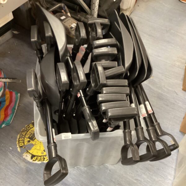 Lot of used plastic snow shovels for winter snow removal.