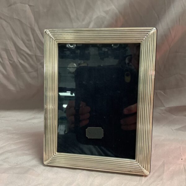 Hallmarked sterling silver photo frame measuring 7x9 inches.