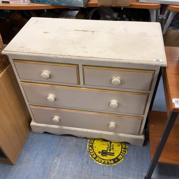 White chest of drawers with two over two drawer configuration.