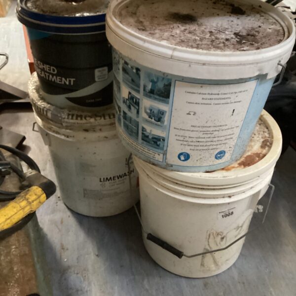 Stack of vintage limewash tubs, antique building materials.