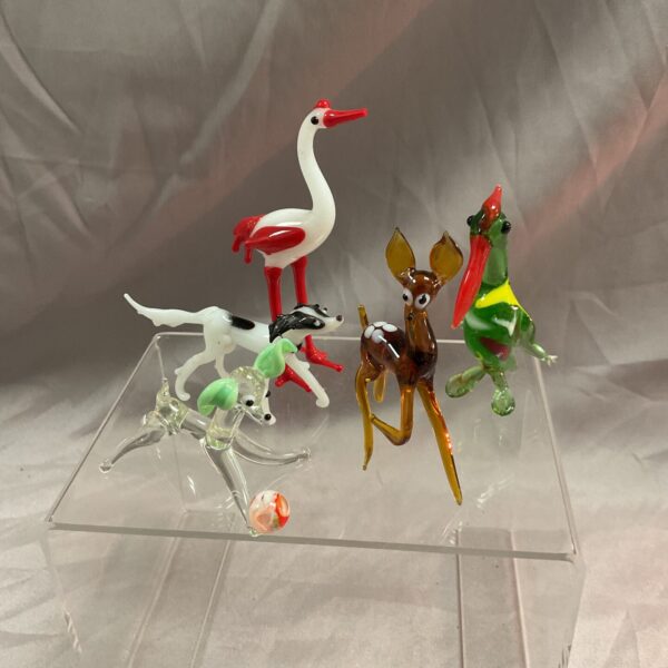 Vibrant Murano glass animal collection featuring a dog, deer, and bird.