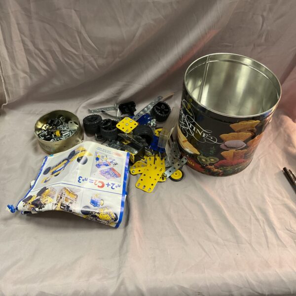 Vintage Meccano set with metal parts in a tin.