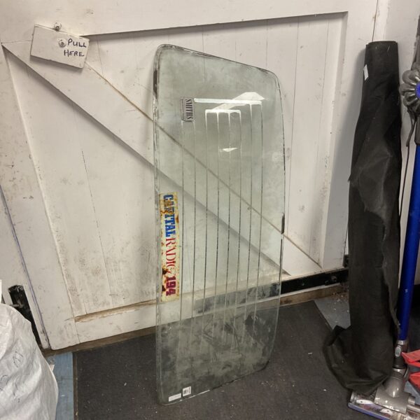 Vintage classic car rear window in used condition.