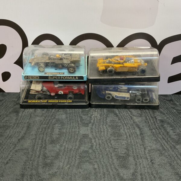 Vintage Scalextric model cars in cases, collectible racing toys.