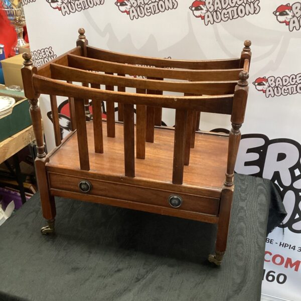 Vintage mahogany Canterbury newspaper rack with drawer and wheels.