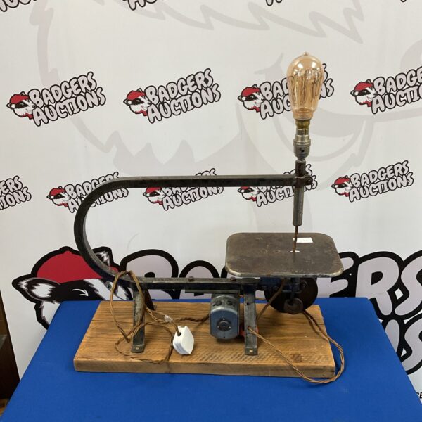Vintage scroll saw lamp with industrial design.