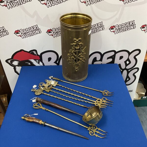 Vintage brass fireplace tools and stick stand for hearth accessories.
